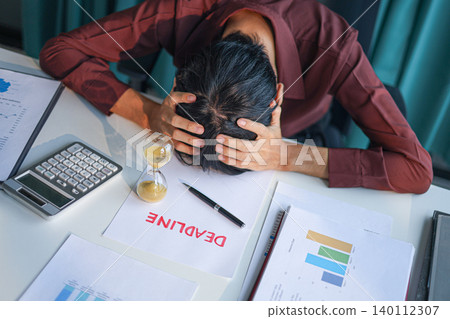 Stressed businessman resting on office desk with deadline paperwork and running sand clock. Time management concept. Stressed businessman resting on office desk with deadline paperwork and running sand clock. Time management concept. 140112307