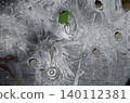 Bullet holes of different calibers on piece of sheet steel 140112381
