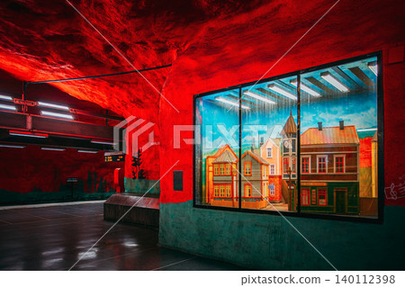 Solna Centrum metro station with red walls and painted mural of houses, Stockholm Solna Centrum metro station with red walls and painted mural of houses, Stockholm 140112398