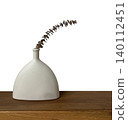 Modern white ceramic vase with dried eucalyptus leaf on wooden shelf isolated on white background. 140112451
