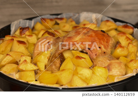 Roasted Chicken Drumsticks with Potatoes on Tray 140112659