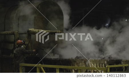 Worker Amidst Steam Near Furnace. Industrial Environment With Worker Surrounded By Smoke And Machinery. Stock Clip Worker Amidst Steam Near Furnace. Industrial Environment With Worker Surrounded By Smoke And Machinery. Stock Clip 140112863