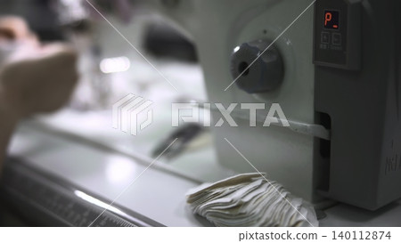 Operator Carefully Modifies Machine Controls While Inspecting Movement Of Cut Materials In Production. Media 140112874