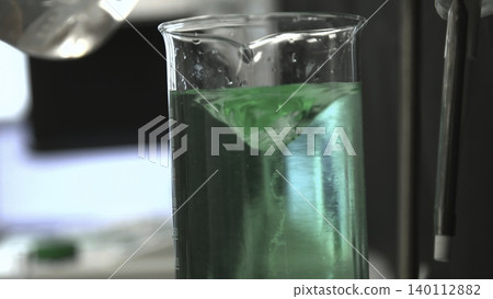 Intimate View Showcasing Beaker Filled With Vivid Teal Fluid Forming Dynamic Vortex Under Intense Backlighting . Stock clip Intimate View Showcasing Beaker Filled With Vivid Teal Fluid Forming Dynamic Vortex Under Intense Backlighting . Stock clip 140112882