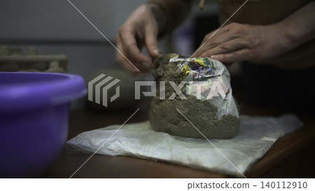 Focus On Hands Carefully Shaping And Smoothing Exterior Surface Of Mold In Crafting Process. Media 140112910