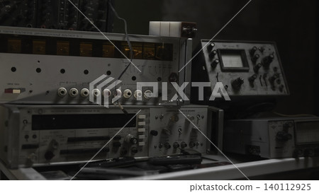 Antique Electronics Setup. Vintage Analog Testing Station With Display And Cable Arrangements In Workshop . Media Antique Electronics Setup. Vintage Analog Testing Station With Display And Cable Arrangements In Workshop . Media 140112925