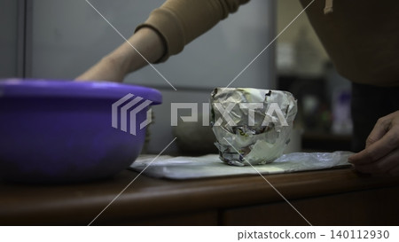 Closeup Of Hands Forming Damp Mud Layers. Studio Technique Of Pressing Moist Soil Into Paper Molds. Media Closeup Of Hands Forming Damp Mud Layers. Studio Technique Of Pressing Moist Soil Into Paper Molds. Media 140112930