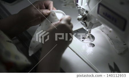 Cotton Fabric Being Expertly Finished. Seamstress Skillfully Shapes And Smooths Cotton Garments At Work. Media Cotton Fabric Being Expertly Finished. Seamstress Skillfully Shapes And Smooths Cotton Garments At Work. Media 140112933