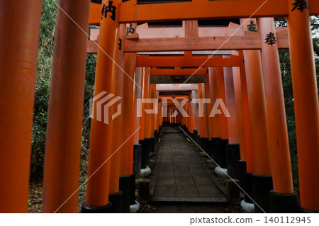 Gallery of red torii gates in a japanese shrine. Gallery of red torii gates in a japanese shrine. 140112945