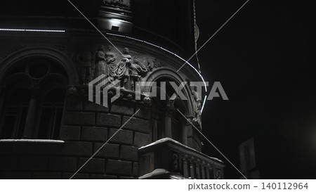 An Intricate Night Scene Of Building With Illuminated Relief Sculptures And Curved Balcony Features. Media An Intricate Night Scene Of Building With Illuminated Relief Sculptures And Curved Balcony Features. Media 140112964