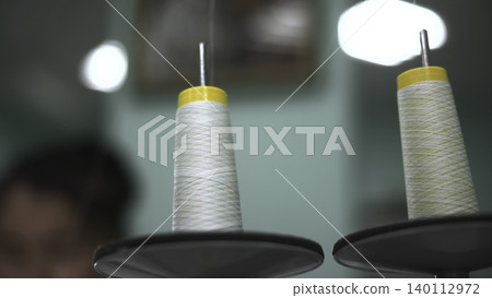 Textile Machine With Blurred Background. Machinery Spools And Tension In Textile Environment. Media Textile Machine With Blurred Background. Machinery Spools And Tension In Textile Environment. Media 140112972