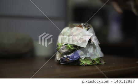 Colorful Paper Being Compacted By Hands. Indoor Scene Showing Hands Folding Recyclable Colored Paper. Media Colorful Paper Being Compacted By Hands. Indoor Scene Showing Hands Folding Recyclable Colored Paper. Media 140112987