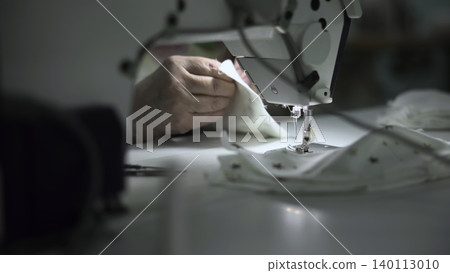 Dedicated Artisan Directs Fabric Through Machinery With Precision And Careful Attention To Detail. Media Dedicated Artisan Directs Fabric Through Machinery With Precision And Careful Attention To Detail. Media 140113010