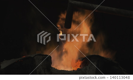 Bright Sparks Fly From Heated Metal. High Temperature Environment With Glowing Molten Metal And Sparks . Stock clip 140113048