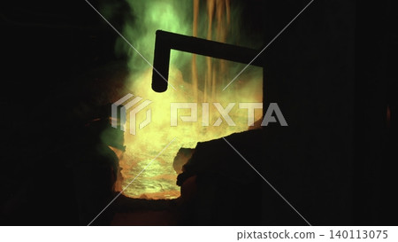 Bright Flames Illuminate Dark Interior. Vivid Scenes Of Molten Metal Flowing Under Green Flames And Smoke . Stock clip 140113075