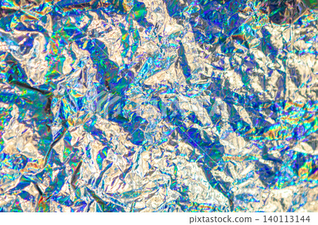 Holographic crumpled foil abstract with iridescent rainbow shine and metallic texture for backgrounds Holographic crumpled foil abstract with iridescent rainbow shine and metallic texture for backgrounds 140113144