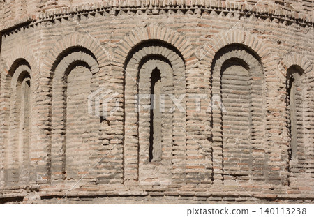 Tower wall with arches relief in brick and mortar. Tower wall with arches relief in brick and mortar. 140113238