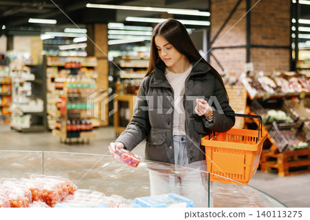 Young woman shopping for fresh produce in supermarket Young woman shopping for fresh produce in supermarket 140113275