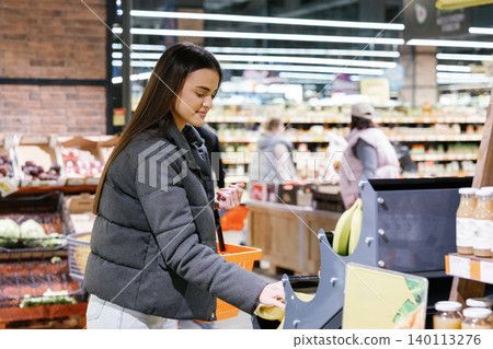 Woman shopping for fresh produce in supermarket Woman shopping for fresh produce in supermarket 140113276