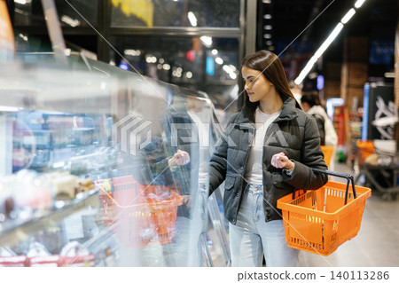 Woman shopping for groceries in supermarket department Woman shopping for groceries in supermarket department 140113286