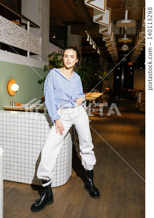 Woman posing in casual fashion outfit in restaurant 140113298