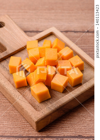 Hard yellow cheddar cheese for sandwiches or pasta. Cheddar cheese 140113423
