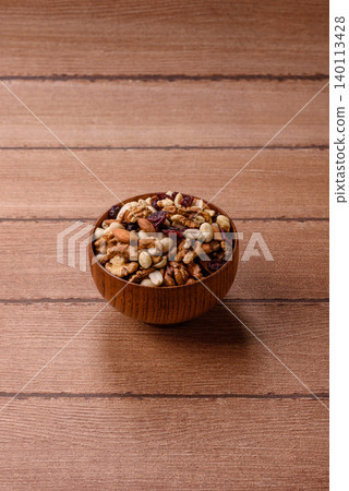 A mix of pistachios, hazelnuts, walnuts, peanuts, dried berries, and fruits. A mix of nuts A mix of pistachios, hazelnuts, walnuts, peanuts, dried berries, and fruits. A mix of nuts 140113428