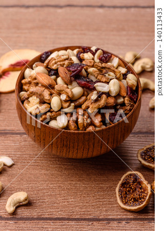 A mix of pistachios, hazelnuts, walnuts, peanuts, dried berries, and fruits. A mix of nuts 140113433