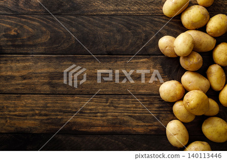 Fresh raw whole potatoes on rustic wooden table, top view 140113446