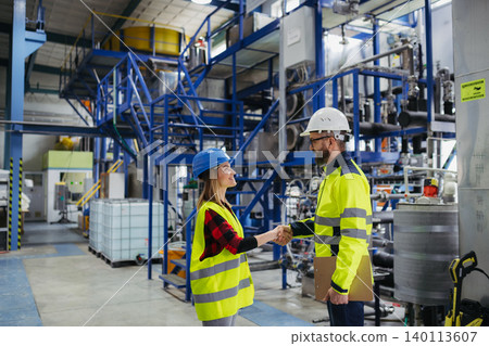 Factory manager and mechanic worker shaking hands industrial factory. 140113607
