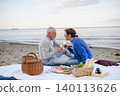 Senior couple in love having romantic picnic on beach by sea. 140113626