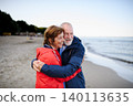 Romantic walk on beach for elderly couple in love. 140113635