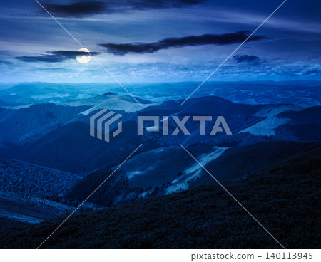 mysterious mountain landscape in summer at night. travel ukraine background. full moon over rolling hill in dappled light. scenic view of borzhava ridge. carpathian mountain scenery mysterious mountain landscape in summer at night. travel ukraine background. full moon over rolling hill in dappled light. scenic view of borzhava ridge. carpathian mountain scenery 140113945