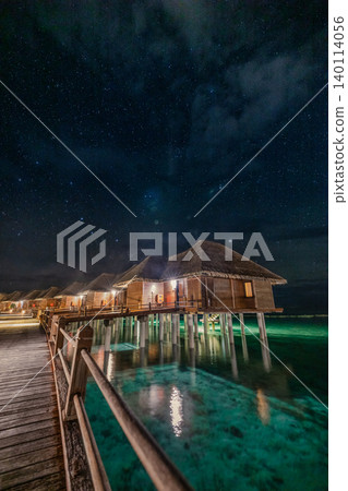 Gorgeous Maldives overwater villa illuminated lights twilight dusk tropical lagoon breathtaking serene romantic luxury resort escape moody atmospheric evening reflection peaceful night ambiance glow Gorgeous Maldives overwater villa illuminated lights twilight dusk tropical lagoon breathtaking serene romantic luxury resort escape moody atmospheric evening reflection peaceful night ambiance glow 140114056