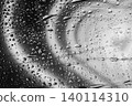 Water drops cover glass surface with monochrome reflections, lines, moisture texture. Natural background design with water drops, copy space, backdrop, abstract rain pattern 140114310