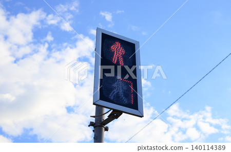 Pedestrian traffic light with red stop symbol against blue sky, crosswalk countdown signal control post closeup Pedestrian traffic light with red stop symbol against blue sky, crosswalk countdown signal control post closeup 140114389