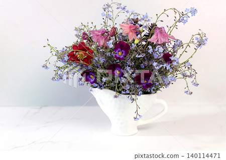 Still life with beautiful spring flowers blooming forget-me-nots,columbine, viola in vase on elegant background. Abstract floral arrangement and banner for screen, floral holiday card Still life with beautiful spring flowers blooming forget-me-nots,columbine, viola in vase on elegant background. Abstract floral arrangement and banner for screen, floral holiday card 140114471