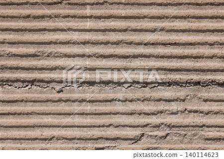 Textured Concrete Wall with Horizontal Ridges and Grooves 140114623