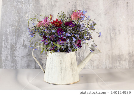 Beautiful spring forget-me-nots, violets, columbine on a sunny background, abstract floral arrangement, still life with spring flowers of different varieties, floral greeting card, screen banner, Beautiful spring forget-me-nots, violets, columbine on a sunny background, abstract floral arrangement, still life with spring flowers of different varieties, floral greeting card, screen banner, 140114989