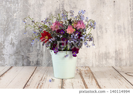 Beautiful spring forget-me-nots, violets, columbine on a sunny background, abstract floral arrangement, still life with spring flowers of different varieties, floral greeting card, screen banner, Beautiful spring forget-me-nots, violets, columbine on a sunny background, abstract floral arrangement, still life with spring flowers of different varieties, floral greeting card, screen banner, 140114994