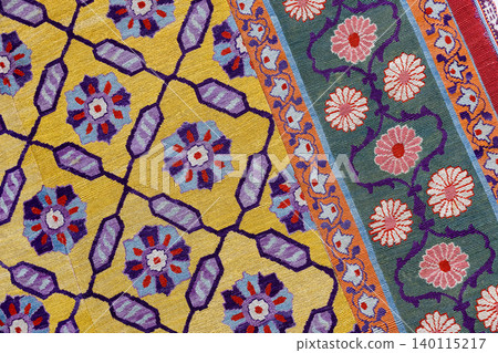 Vibrant woven rug featuring intricate floral motifs and geometric lattice Vibrant woven rug featuring intricate floral motifs and geometric lattice 140115217