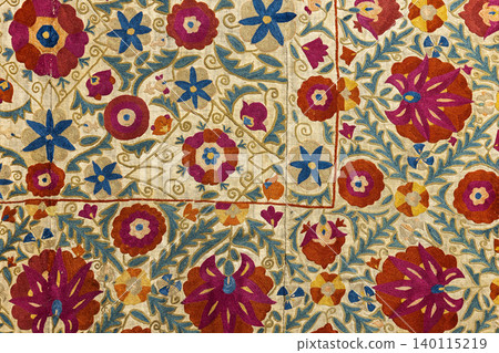 Colorful embroidery on a traditional textile featuring hand-stitched Uzbek floral motifs Colorful embroidery on a traditional textile featuring hand-stitched Uzbek floral motifs 140115219