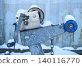 Close-up of metal trailer winch, used for pulling boat onto the trailer. Outside marina or harbor on winter day 140116770