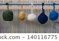 Balls of colored yarn on metal bar of rug-weaving loom. Ancient carpet weaving craft, workshops and regional and international festivals. Creating traditional oriental rugs. Textile texture 140116775