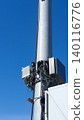 Small cell wireless installation, blue sky on background. Cellular base station for 5G and high-capacity 4G LTE networks. Equipment for transmitting and receiving signals, connection 140116776