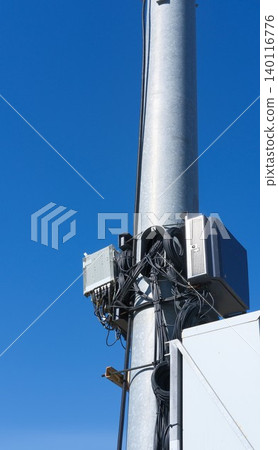 Small cell wireless installation, blue sky on background. Cellular base station for 5G and high-capacity 4G LTE networks. Equipment for transmitting and receiving signals, connection 140116776