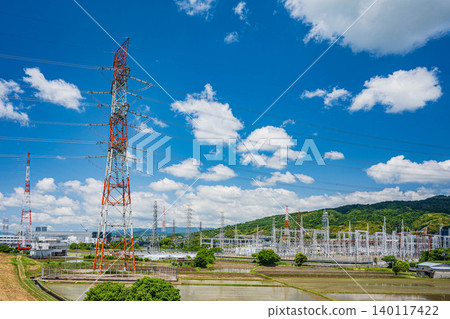 A Kansai Electric Power Company substation and a transmission tower standing amidst rice fields in Takatsuki City, Osaka Prefecture. 140117422
