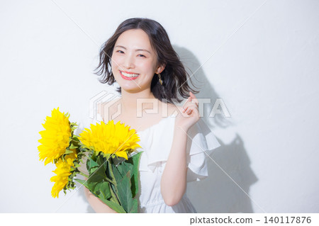 Woman with a bouquet of sunflowers Woman with a bouquet of sunflowers 140117876
