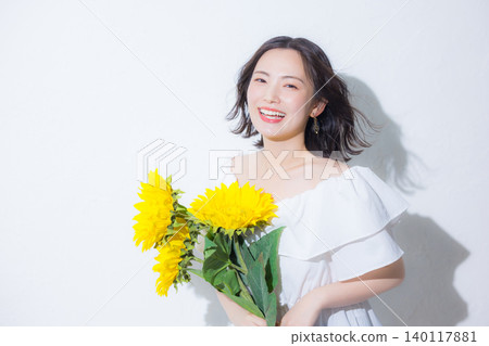 Woman with a bouquet of sunflowers Woman with a bouquet of sunflowers 140117881