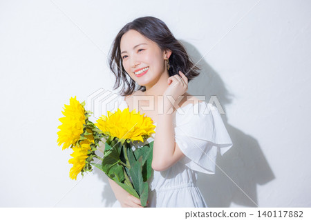 Woman with a bouquet of sunflowers Woman with a bouquet of sunflowers 140117882